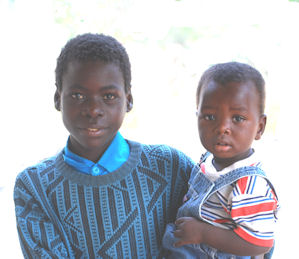Two AIDS orphans, one being held by an older brother
