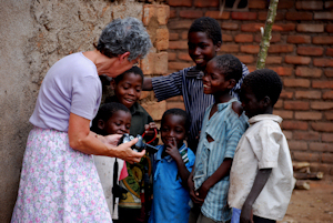 Missions team nurse checks on small orphans