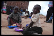 Orphans enjoying a meal at the opening of a new feeding center in Mozambique