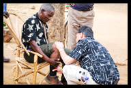 Dr. Arun Agarwaal examines the knee of an elderly patient in a Mozambique village