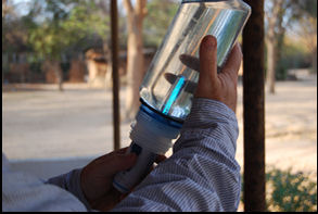 Team member sterilizing Water with a Steri-pen in Bangula, Malawi